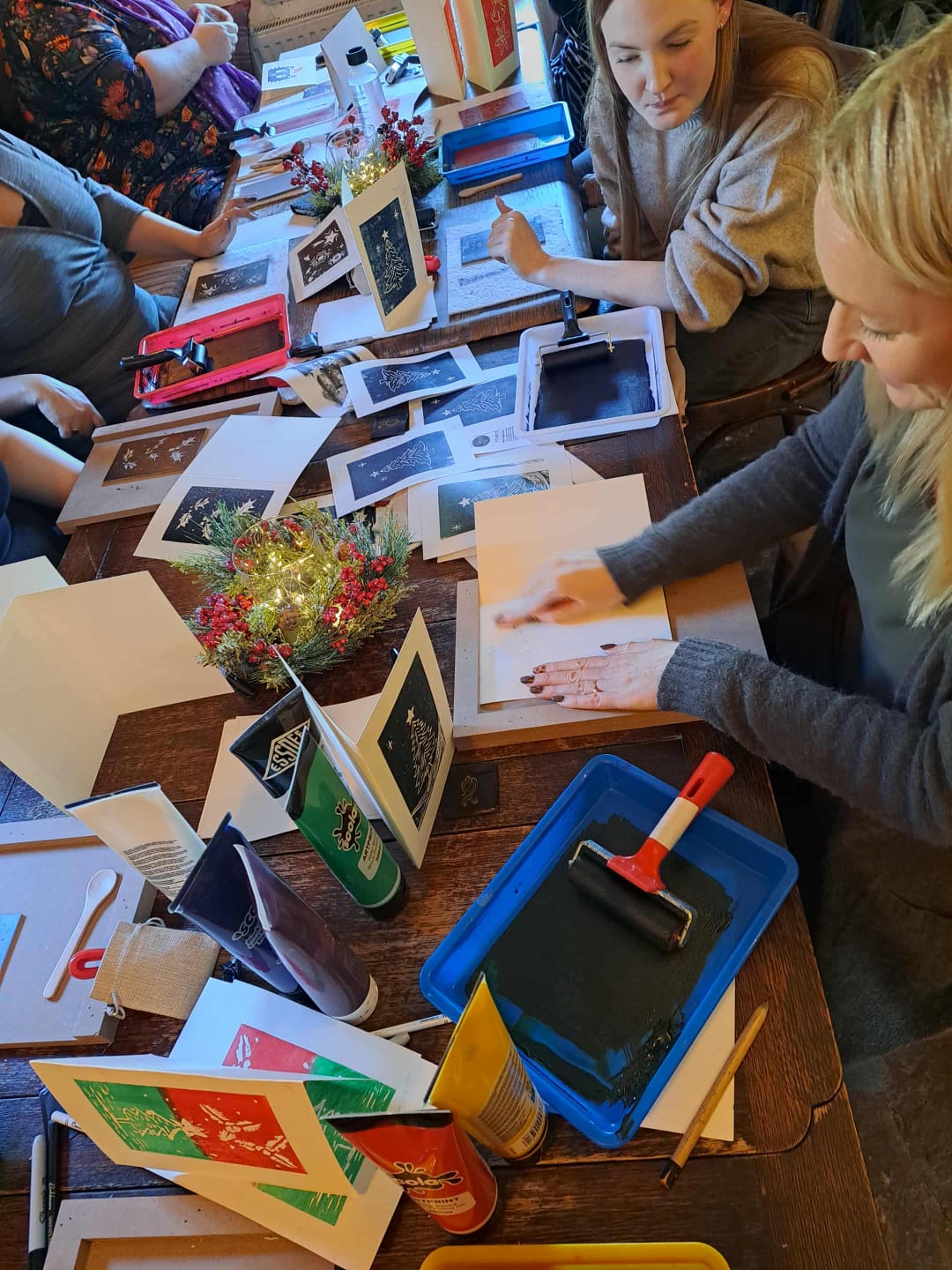 Overhead view of a lino printing workshop with hand-printed Christmas cards